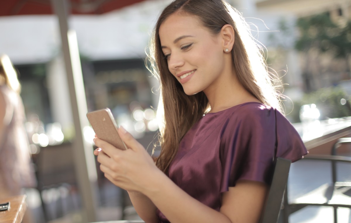 young woman standing side by side reading social media